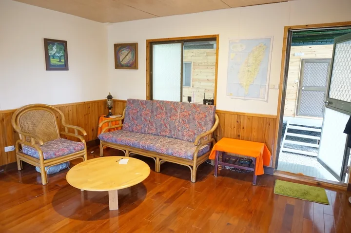 A volunteer sitting room with a sofa, chairs and a low table
